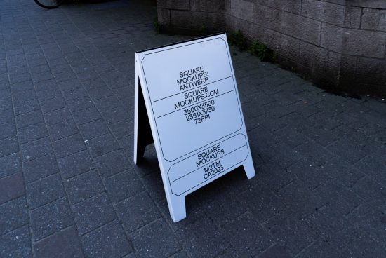 Outdoor sandwich board mockup with editable design standing on street pavement, suitable for graphic design and advertising presentations.